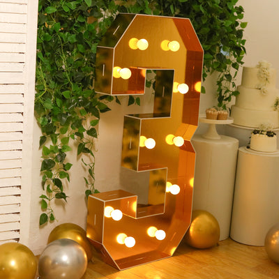 Gold marquee number three with lights, ideal for celebrations and events.