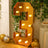 Gold marquee number three with lights, surrounded by greenery and balloons.
