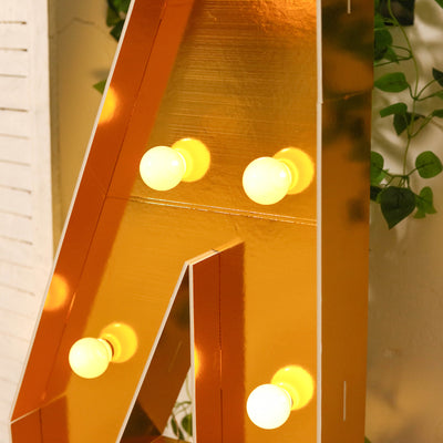 Gold marquee letter "A" with light bulbs, perfect for decor.