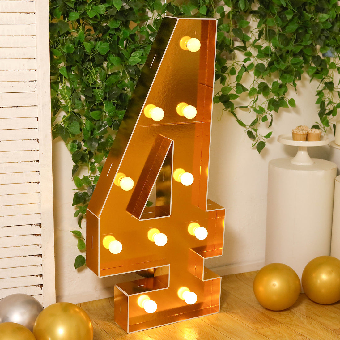 Large illuminated number 4 marquee sign in a festive setting.