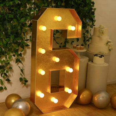 Gold marquee number six with lights, perfect for celebrations and events.