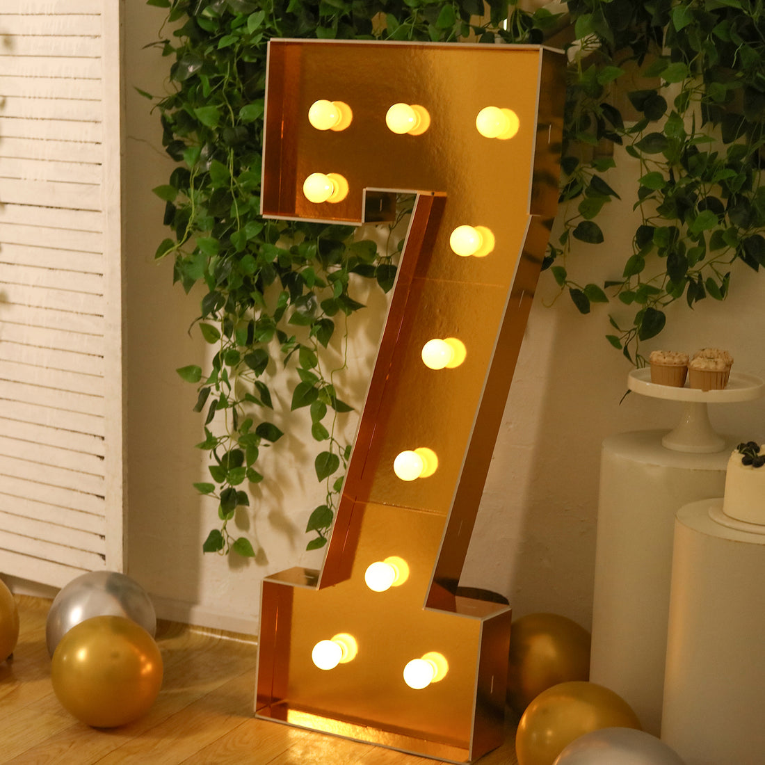 Gold number 7 marquee sign with lights, perfect for celebrations and events.