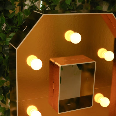 Gold-framed mirror with lights, perfect for vanity or makeup applications.