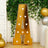 Gold marquee letter A with bulbs, green vines, and balloons for party decor