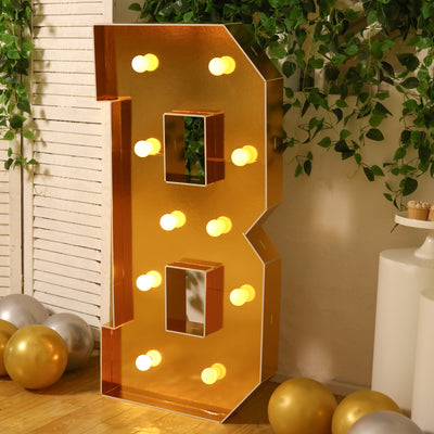 Gold marquee letter 'B' with lights, perfect for party decor.