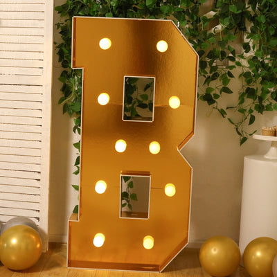 Gold letter B marquee sign with lights, perfect for events and celebrations.