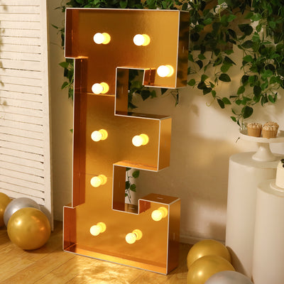 Gold marquee letter "E" with lights, perfect for events and celebrations.