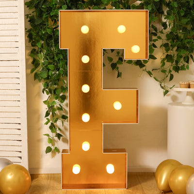 Gold marquee letter "E" with lights, perfect for events or celebrations.