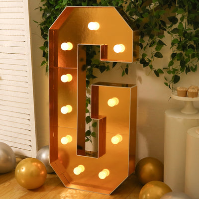 Gold marquee letter "G" with lights, perfect for events and celebrations.