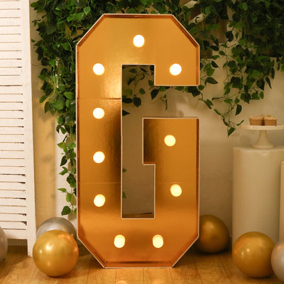 Gold marquee letter "G" with lights, perfect for events and celebrations.