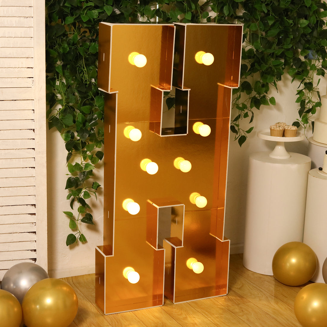 Gold marquee letter "H" with lights, perfect for events and celebrations.