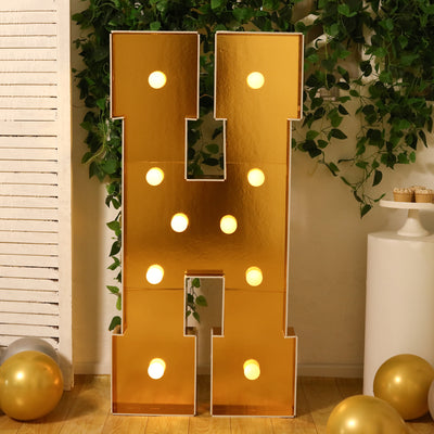 Gold marquee letter "H" with lights, perfect for celebrations and events.