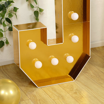 Gold marquee letter with bulbs, perfect for events and decor.