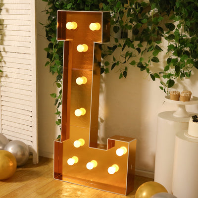 Gold marquee letter "L" with lights, perfect for events and decorations.