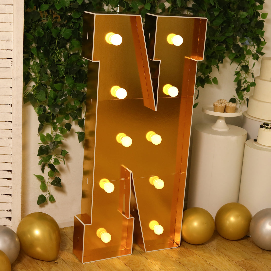 Gold marquee letter "N" with lights, perfect for events and decor.