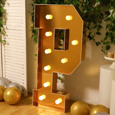 Gold letter "P" marquee sign with lights, set in a decorated party scene.