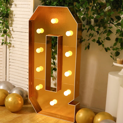 Gold marquee letter "Q" with lights, perfect for events and celebrations.