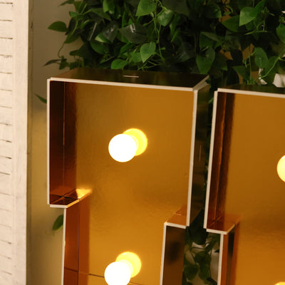 Gold decorative letter lights with bulbs, perfect for home decor.