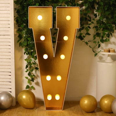 Gold marquee letter "V" with lights, perfect for celebrations or events.