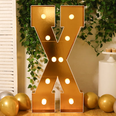 Gold marquee letter "X" with lights, perfect for events and celebrations.