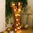 Gold marquee letter "Y" with lights in a festive setting.