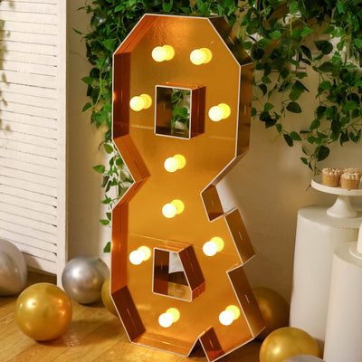 Golden marquee number 8 illuminated with bulbs, perfect for celebrations.