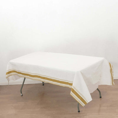 White tablecloth with gold stripes on a folding table