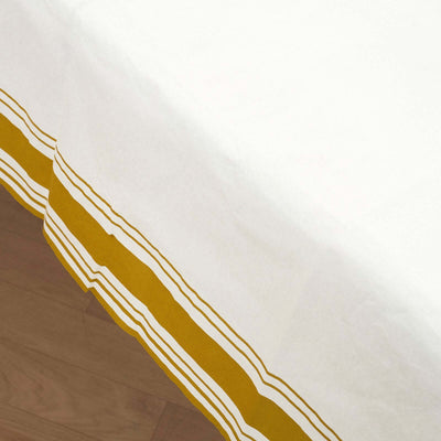 White tablecloth with yellow and white striped border.