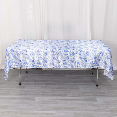 Blue floral tablecloth on a folding table in a studio setting.
