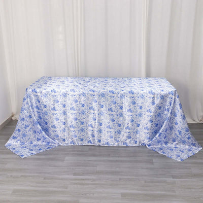 Blue floral tablecloth on a table against a light backdrop.