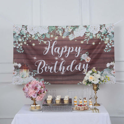 Birthday celebration backdrop with flowers and lanterns.