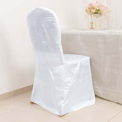 White chair cover draped over a chair in a bright setting.