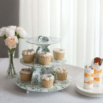 Three-tier cupcake stand with decorated cupcakes and desserts on a table.