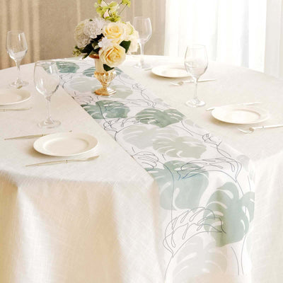 Floral table runner on a dining table with glasses and plates.