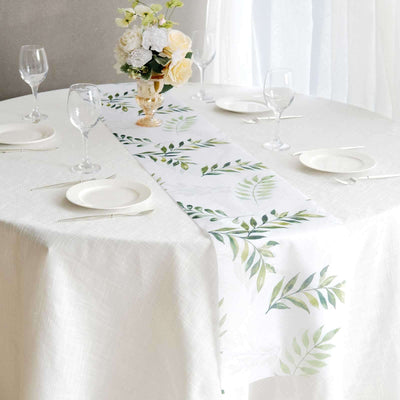 Table runner with green leaf pattern on a white table setting.