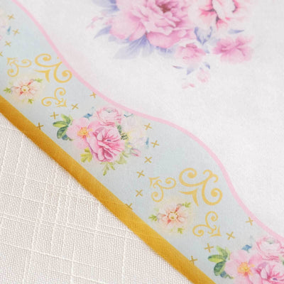 Floral patterned wrapping paper with delicate pink and gold details.