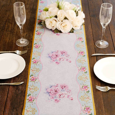 Elegant floral table runner on a rustic wooden table setting.