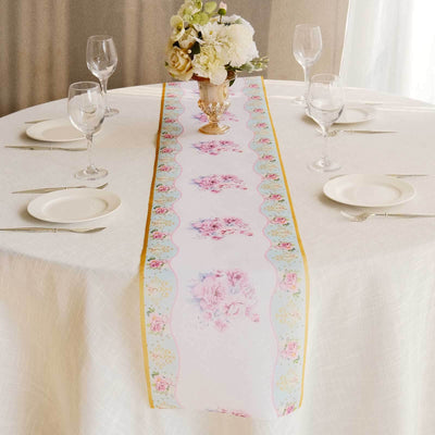 Floral table runner on an elegantly set dining table with glassware and plates.