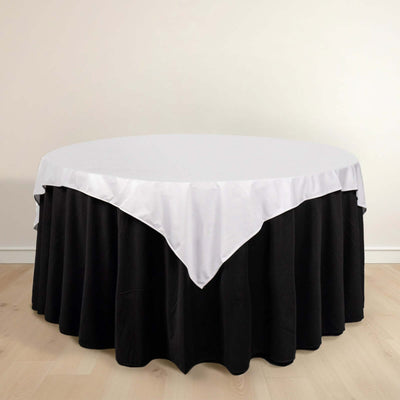 Round table with black skirt and white tablecloth