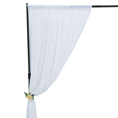 White sheer fabric draped on a black stand with a rose accent