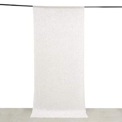 White sheer fabric curtain hanging against a plain backdrop