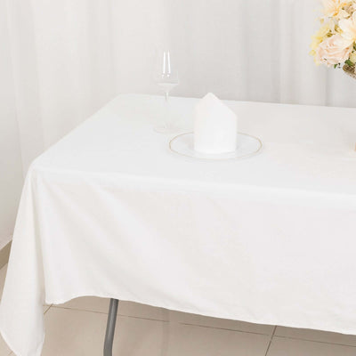 White tablecloth with a decorative plate and glass on a clean table