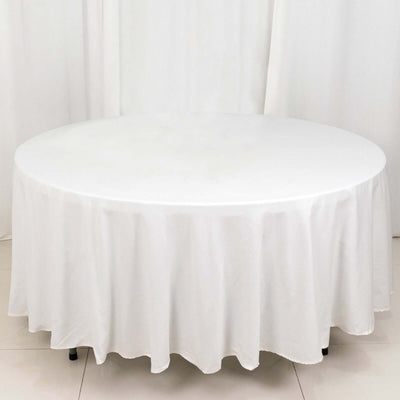 Round white tablecloth draped elegantly over a circular table.
