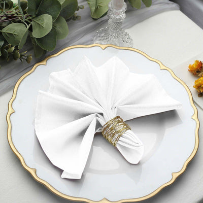 Elegant white napkin folded creatively on a decorative plate.