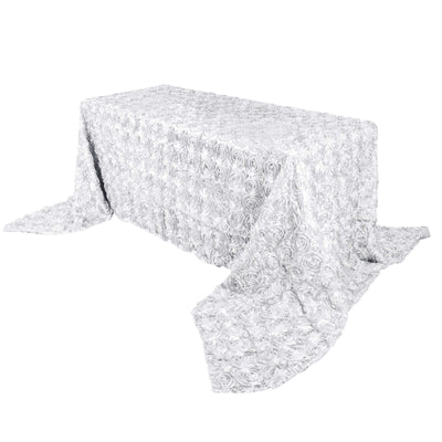 White rose-patterned tablecloth draped on a table