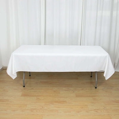 White tablecloth draped over a folding table in a bright setting.