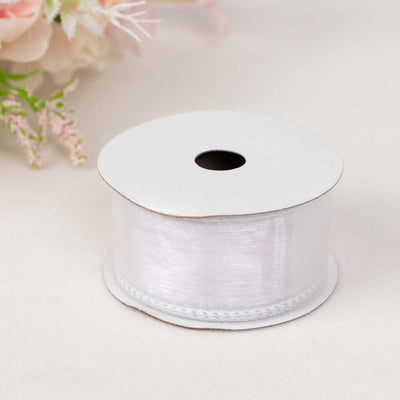 White satin ribbon on a spool, perfect for crafts and decorations.