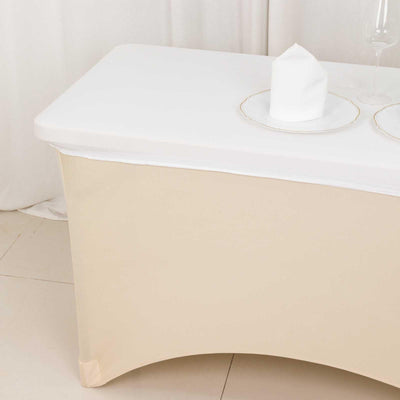 Elegant beige table with white tabletop, styled with a plate and glass.