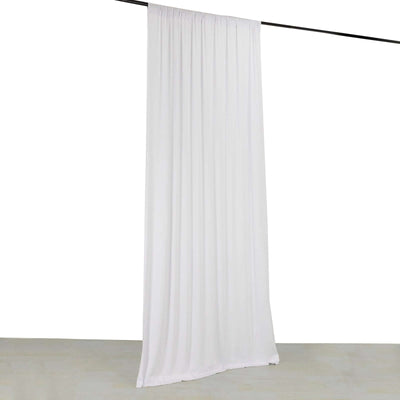 White curtain hanging on a rod in a studio setting