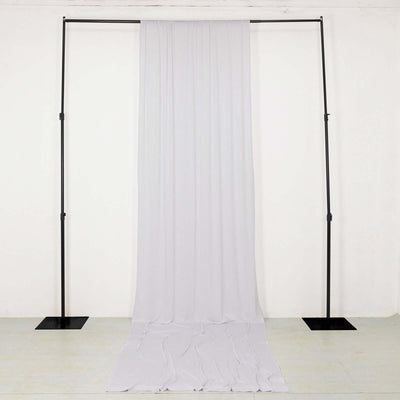 Fabric backdrop stand with draped white fabric for photography.